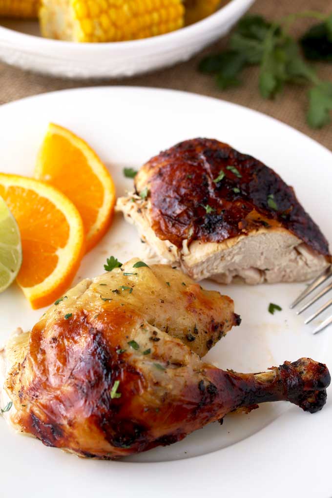 Two pieces of Cuban Chicken seasoned with Mojo Marinade on a plate.