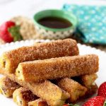 These Nutella French Toast Roll-Ups are a fun, finger-friendly treat for breakfast or brunch. These portable, and easy to make French Toast Roll Ups are filled with delicious Nutella, dunked into custard, sauteed until golden brown and then rolled in cinnamon sugar goodness!