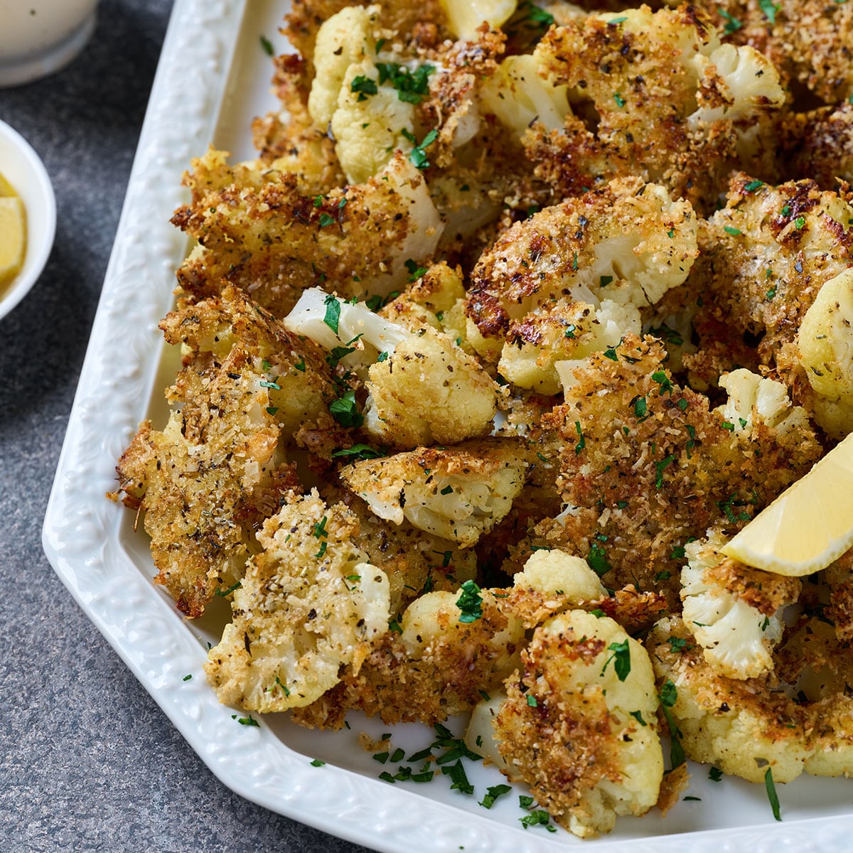 Crispy roasted cauliflower with Parmesan coating on a platter