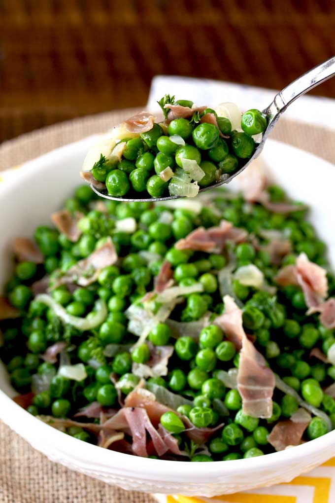 Picture here a spoonful of Sauteed Peas with Prosciutto and Shallots