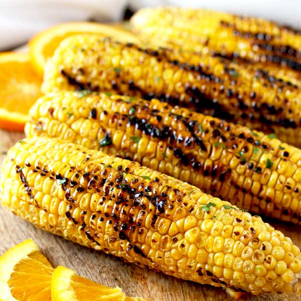Perfectly grilled corn slathered in the most irresistible, flavorful and easy to make Orange Honey Butter. This grilled corn recipe is the perfect side dish for summer days!