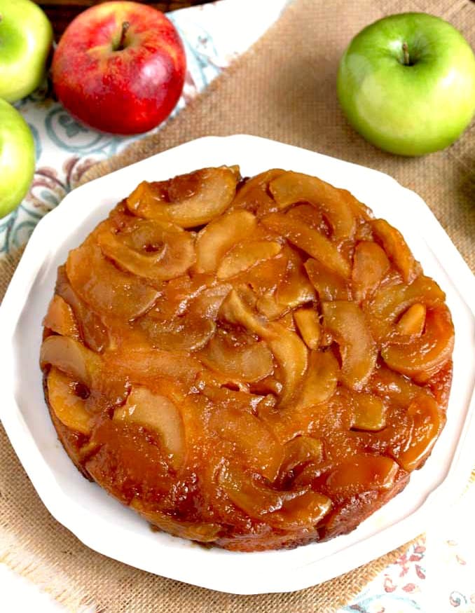 Top view of caramelized cinnamon apples on apple cake