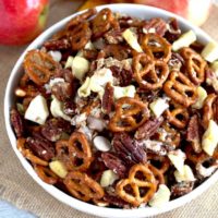 Caramel Apple Pie Party Mix in a white bowl.