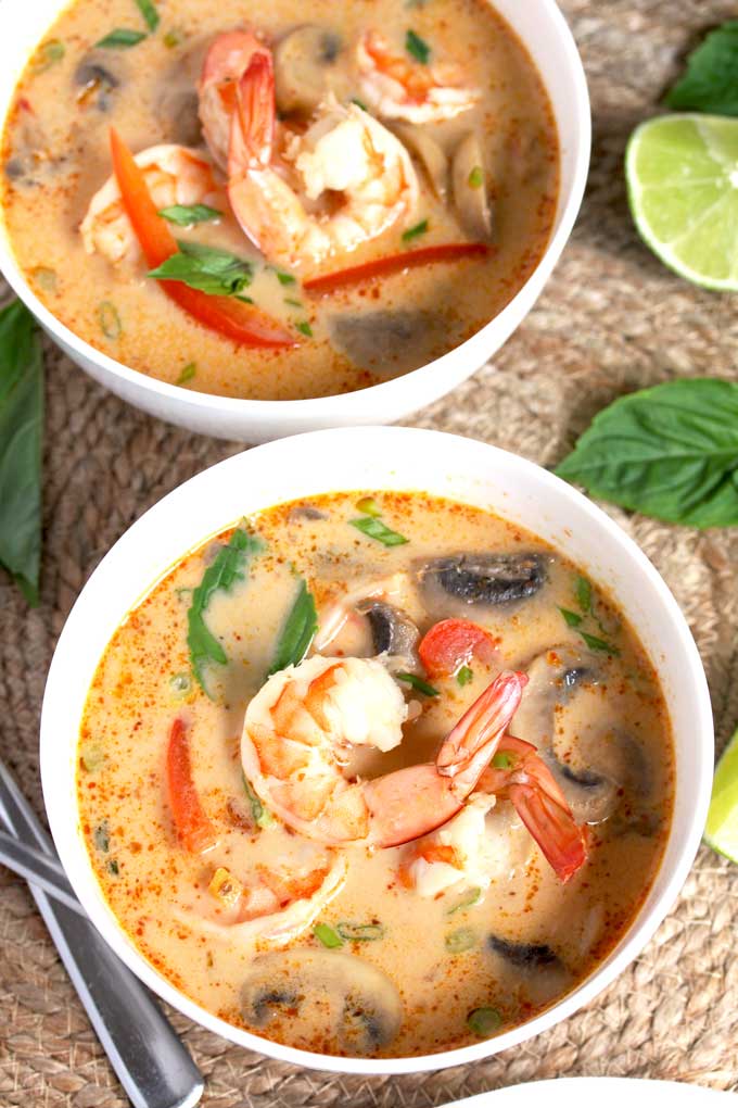 Two white bowls with Coconut Curry Soup with Shrimp. 