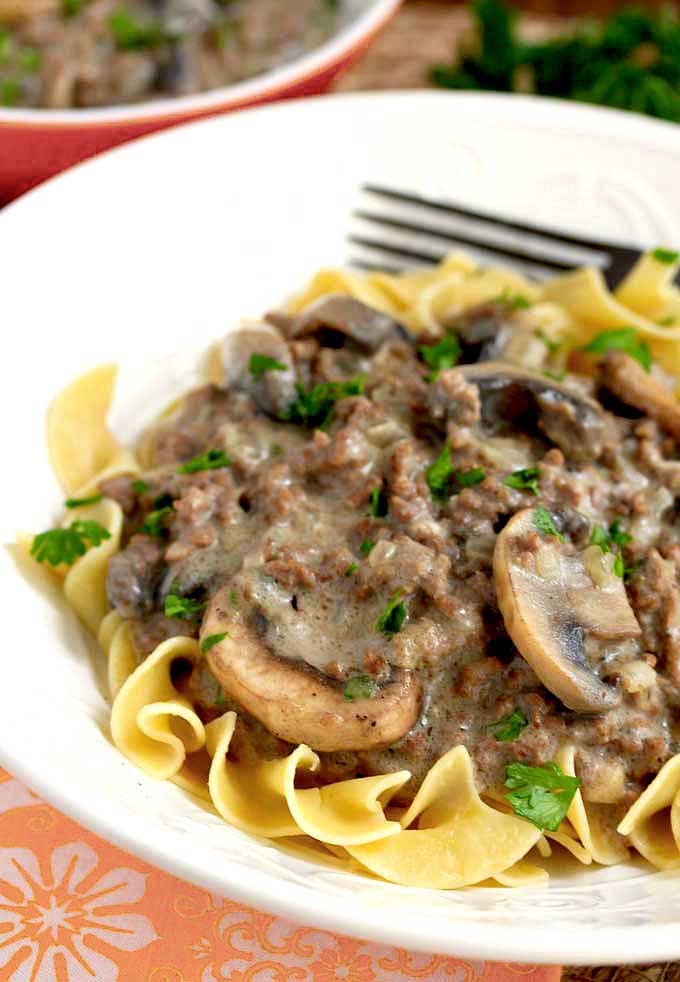 Ground Beef Stroganoff over egg noodles in a white bowl