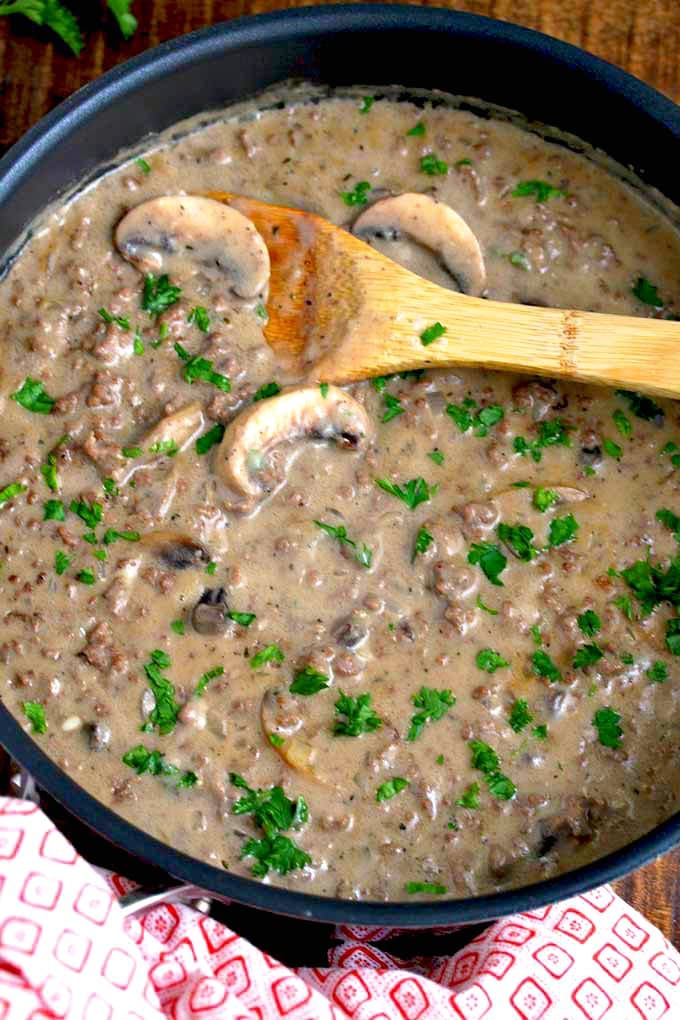 A skillet filled with creamy stroganoff with ground beef and mushrooms.