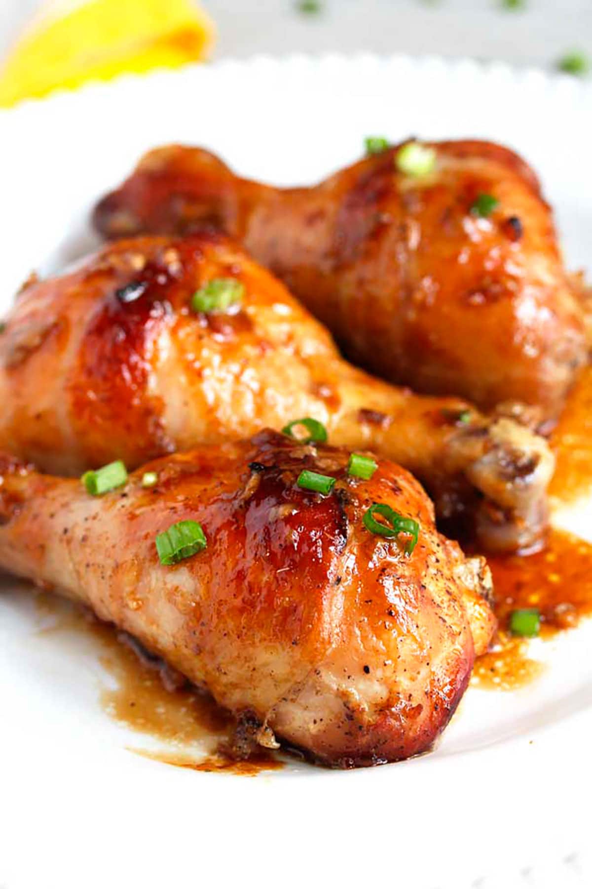 Dinner plate filled with golden brown, crispy and juicy baked chicken drumsticks.