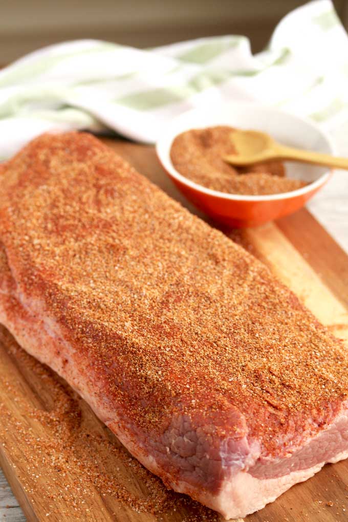 A piece of brisket seasoned with a spice rub mix.