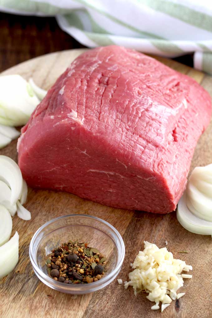 Picture here some of the ingredients to make this sauerbraten recipe. Eye of Round Roast, pickling spices, sliced onions and minced garlic.