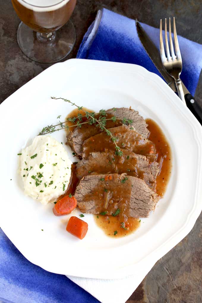 Plated sourbraten with mashed potatoes and carrots