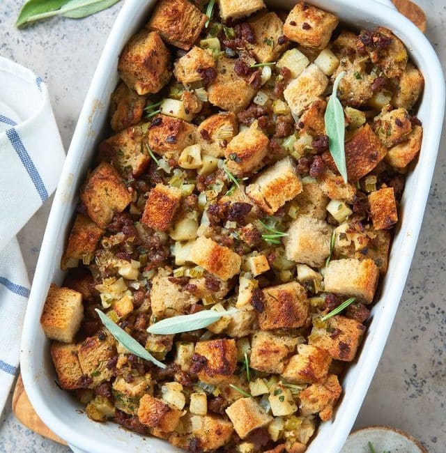 top view of sausage and herb stuffing in a white baking dish