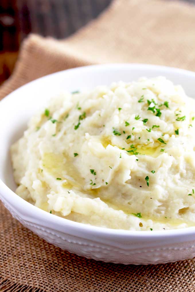A bowl of Instant Pot Mashed Potatoes with melted butter.