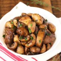 A batch of sauteed mushrooms recipe served on a white bowl
