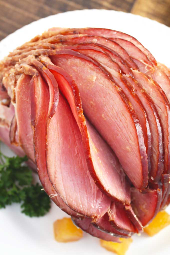 Sliced Slow Cooker Spiral Ham on a white platter