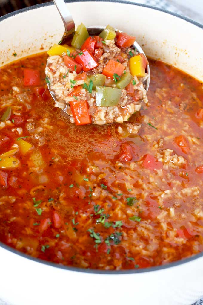 Stuffed Pepper Soup ladled form a Dutch oven,