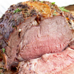 This Prime Rib Roast Recipe is elegant, tasty, easy to make and perfect for the holidays! This Herb Crusted Prime Rib Roast is tender, juicy and cooked to perfection! Plus, I will share with you everything you need to know about buying and cooking Prime Rib!