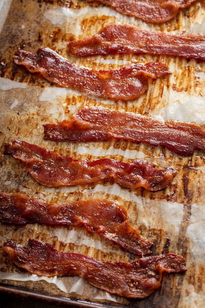 Crispy bacon on a parchment lined baking sheet