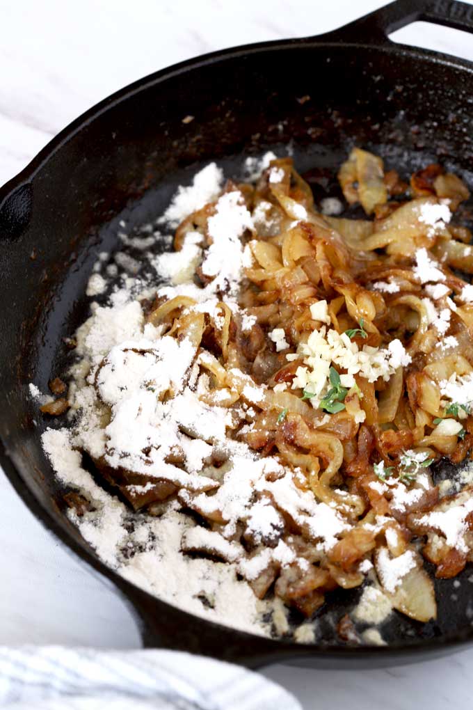 Caramelized onions, garlic, thyme and flour in a skillet.