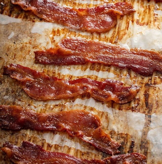 Crispy bacon on a parchment lined baking sheet