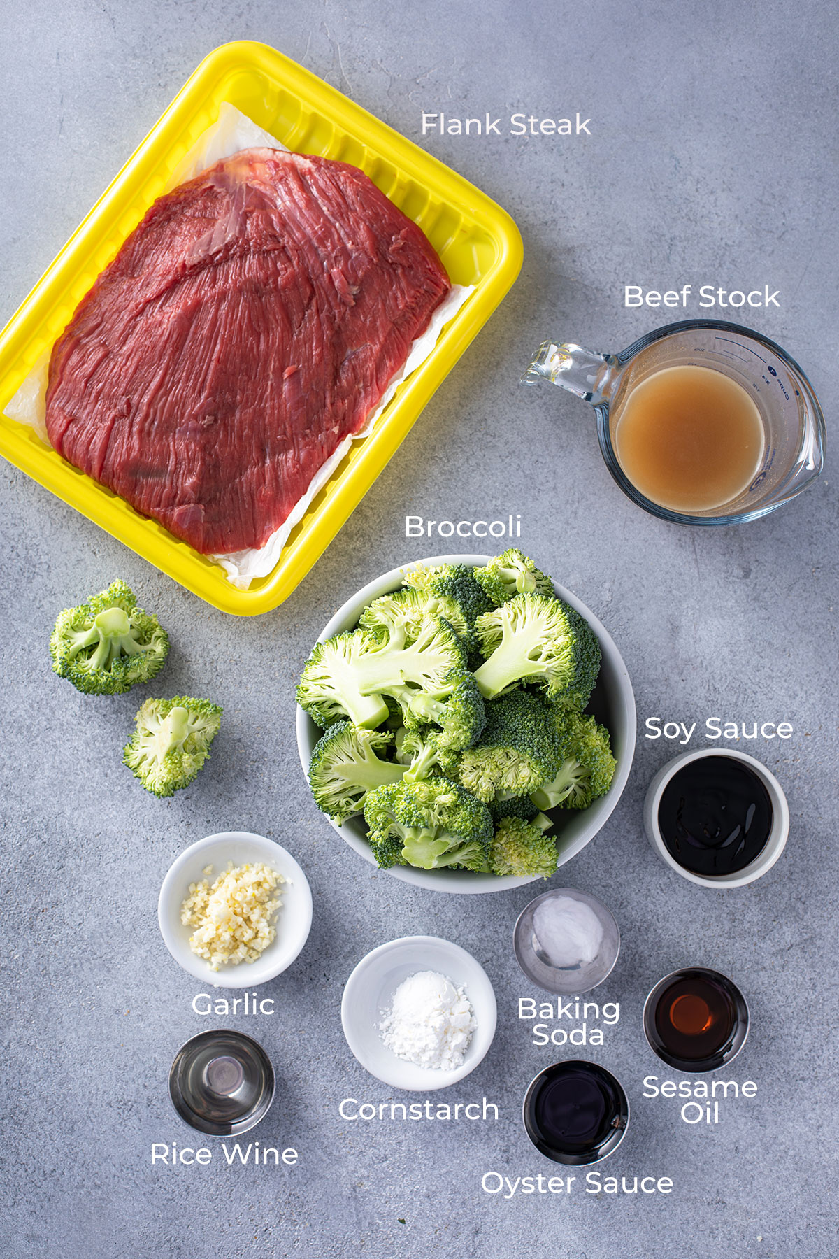 Sliced beef, broccoli and scallions on a wooden board,