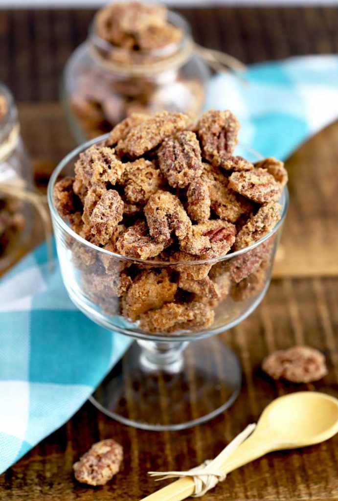Candied pecans on a glass container.