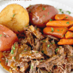 Pin image of pot roast with potatoes, carrots and gravy on a white plate