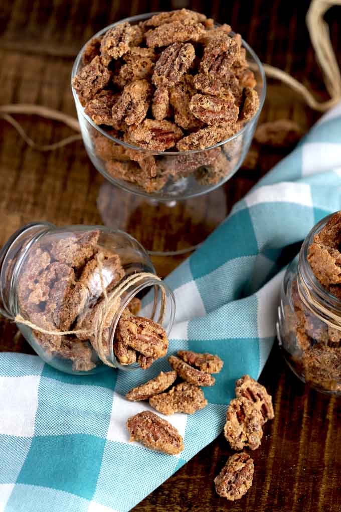 Candied pecans in different containers.
