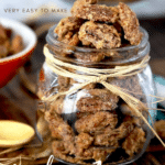 Pin image of a glass jar filled with candied pecans.