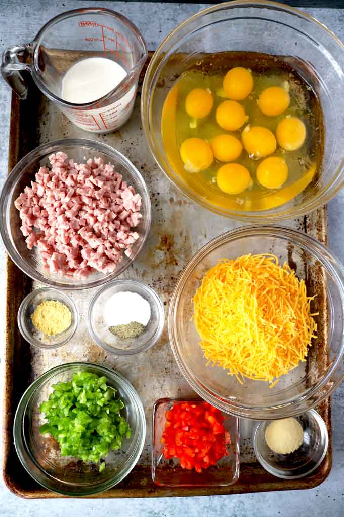 A tray with ingredients to make egg muffins.