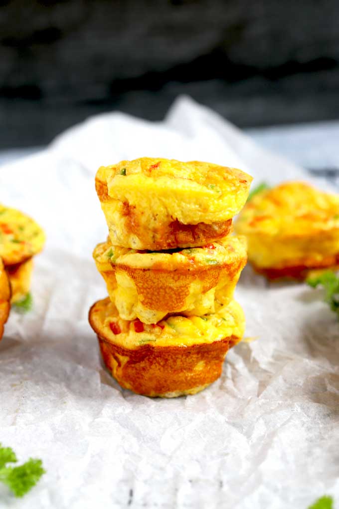 Stack of 3 egg muffins on a cooling rack.
