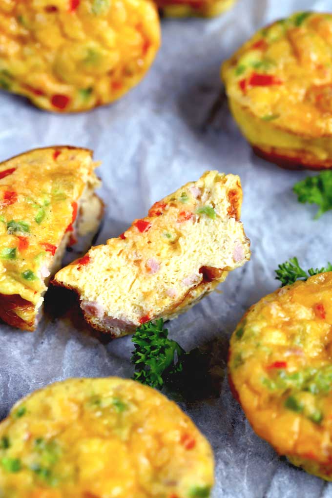 Egg muffin cut in half around other egg muffins.