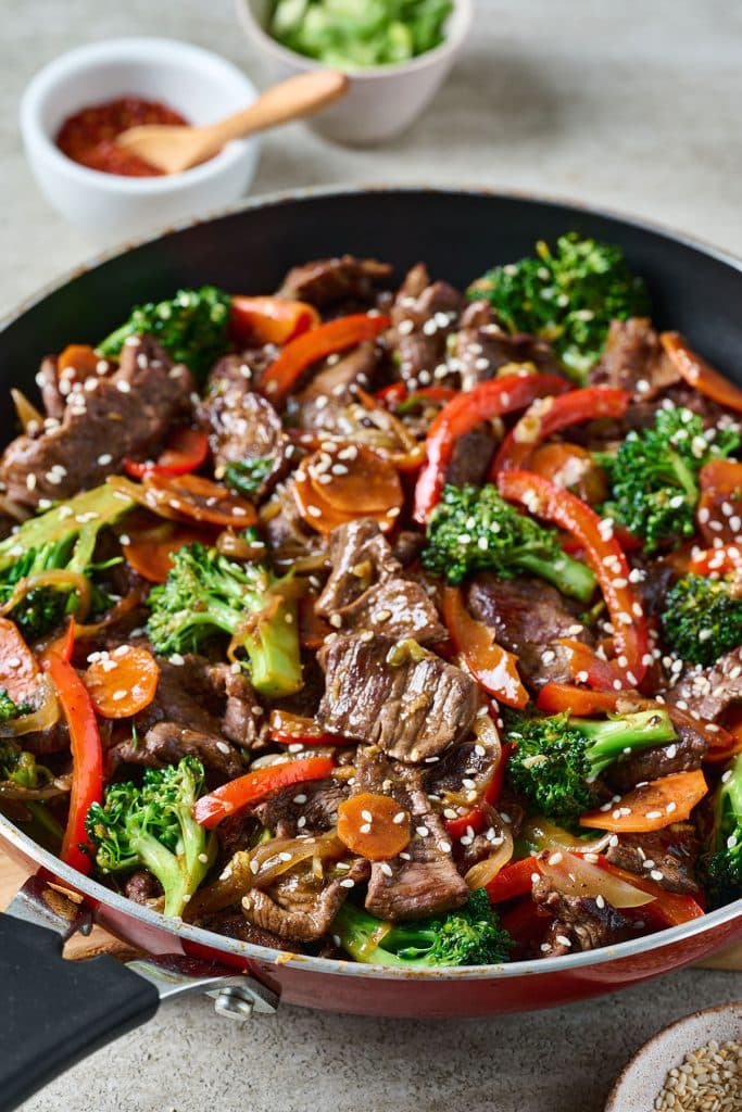 beef stir fry with veggies in a pan