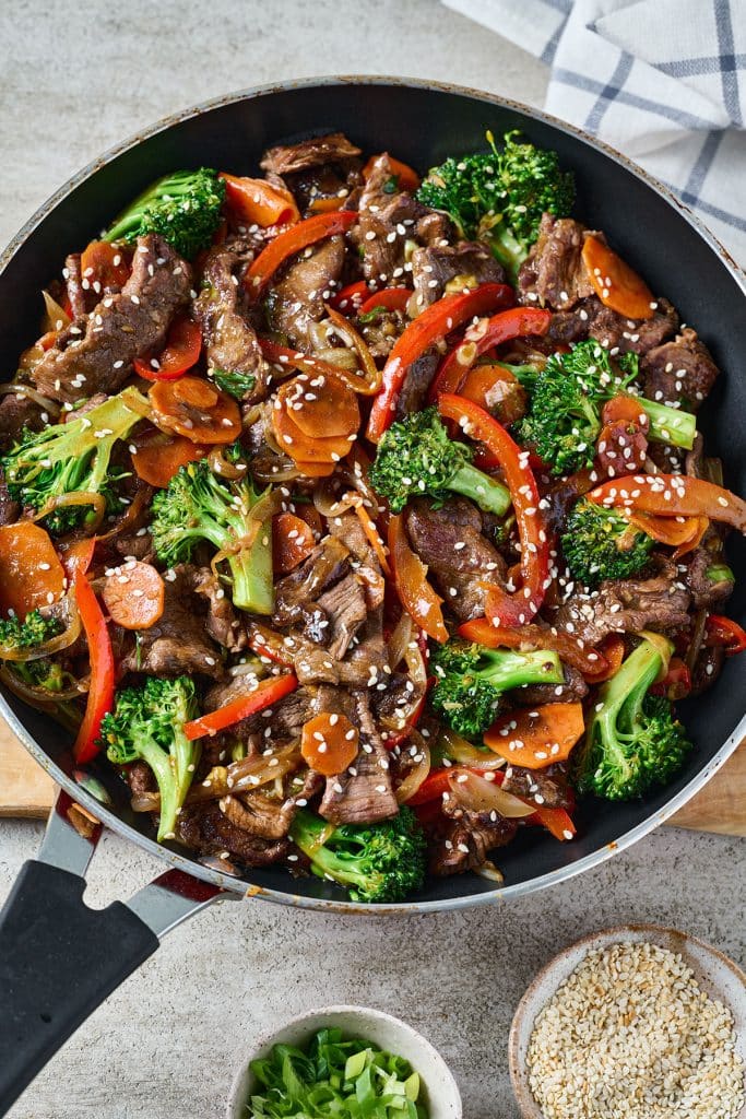 top view of stir fry beef and veggies in a pan