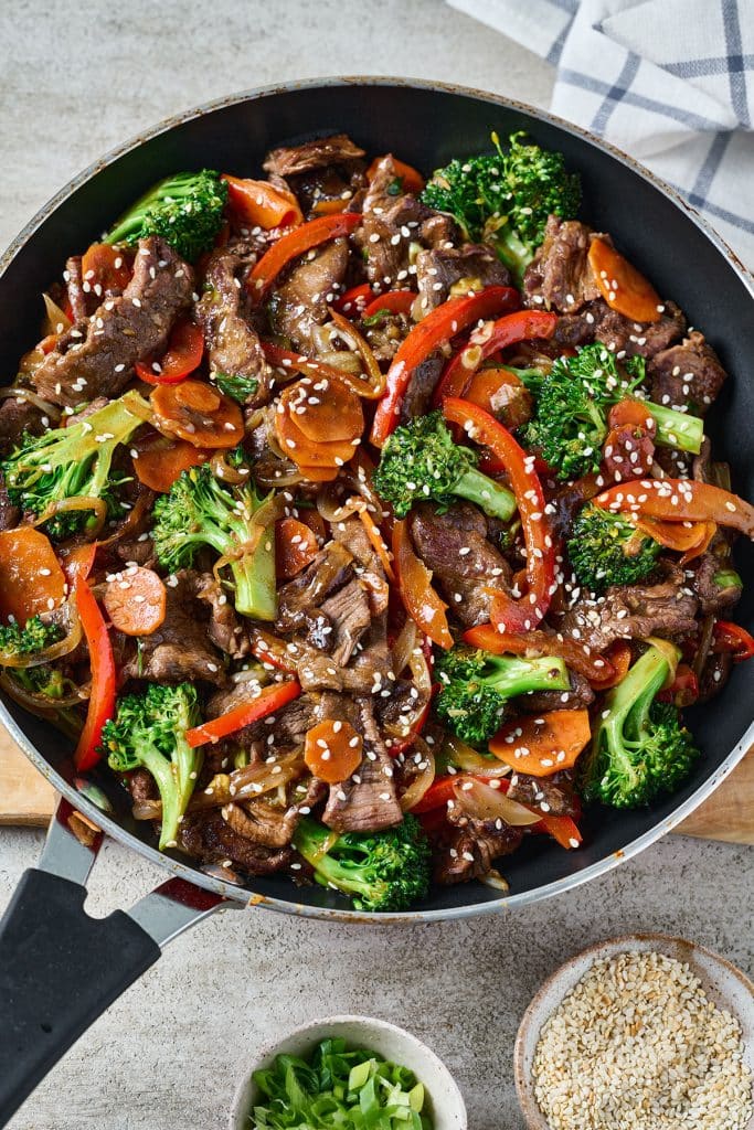 top view of stir fry beef and veggies in a pan