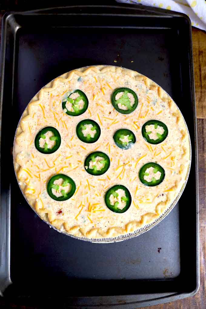 Egg custard in a pie crust, topped with cheese and jalapeno slices.