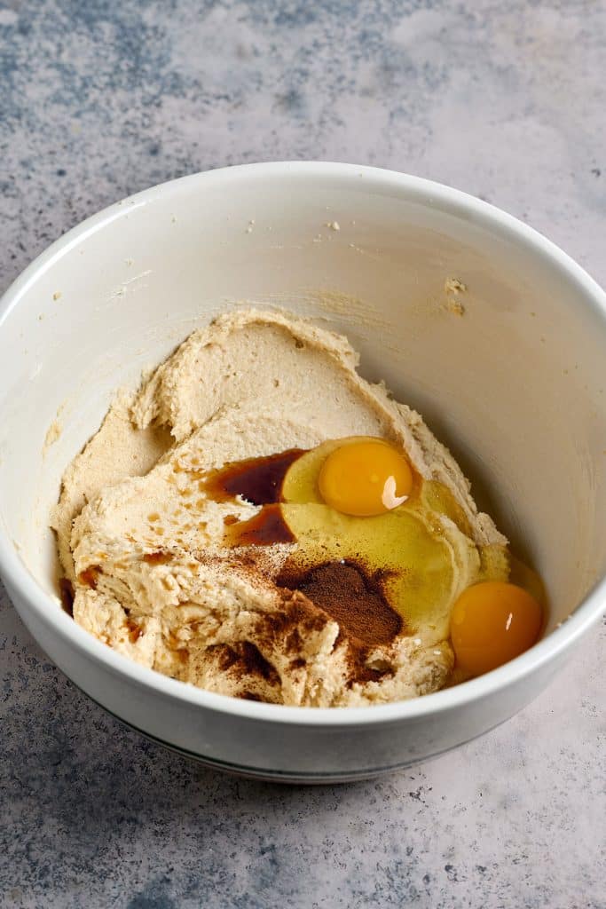 butter, sugar, two eggs and vanilla extract in a bowl