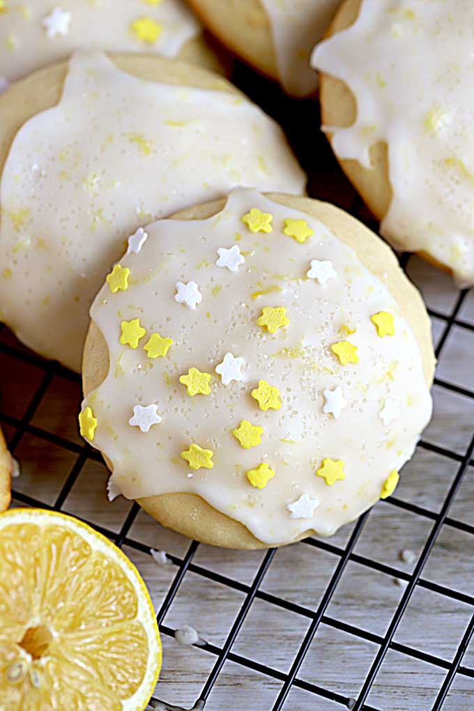 Close up of a lemon ricotta cookie with white and yellow sprinkles.