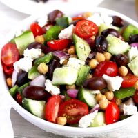 A white bowl filled with Mediterranean Garbanzo Bean Salad