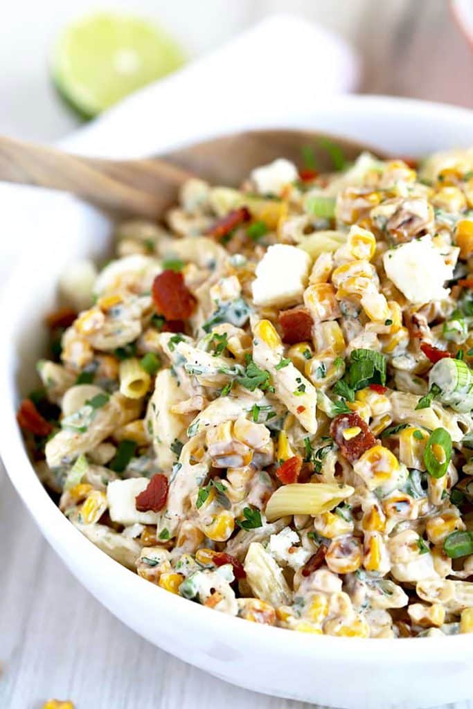 Close up view of Mexican Street Corn Pasta Salad in a white bowl.