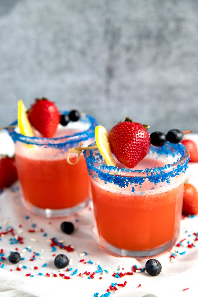 Two glasses of red white and blue 4th of July Strawberry Lemonade Cocktail 