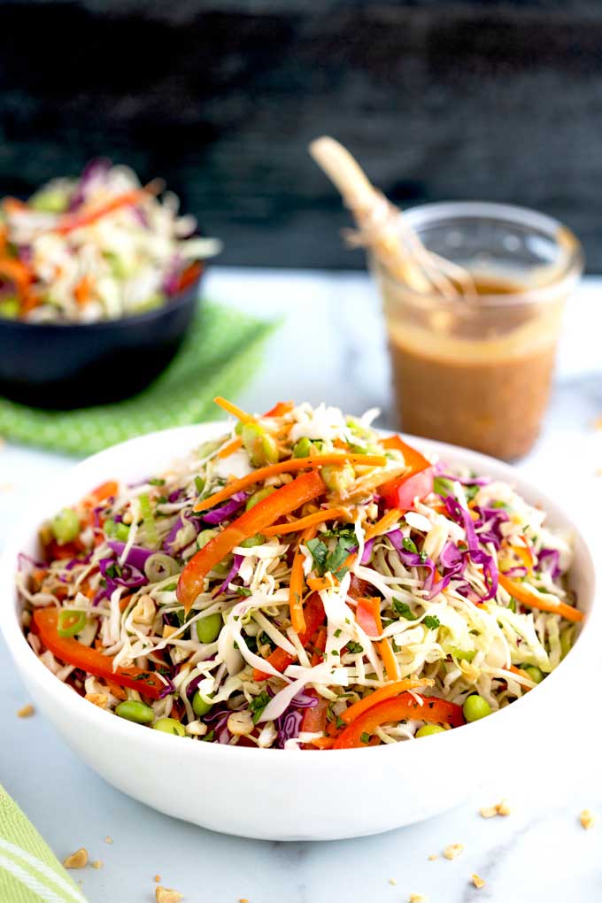 Asian Slaw piled up in a white salad bowl.
