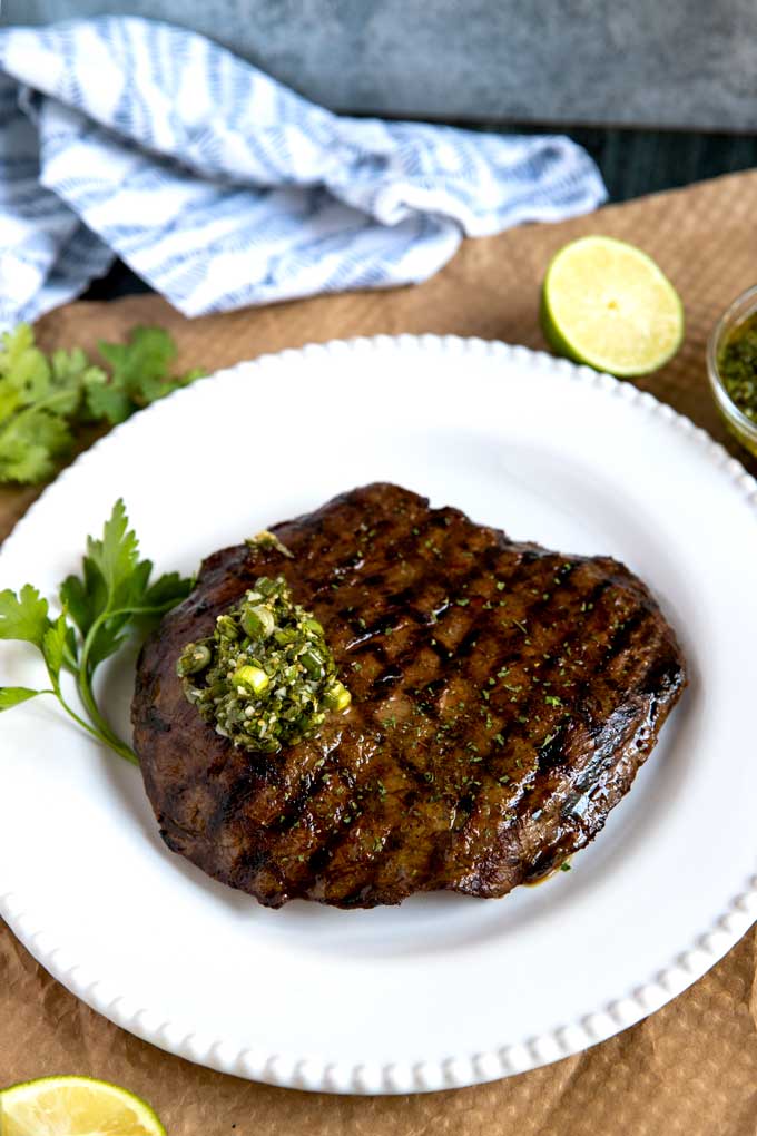 Sliced flank steak grilled and topped with Asian herb sauce.