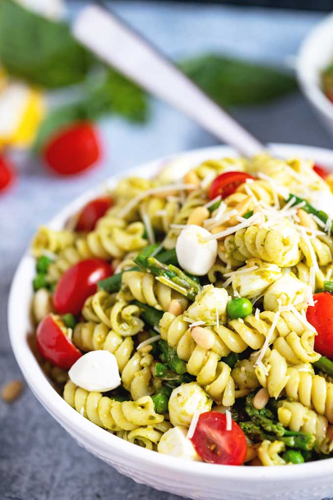 Close up view of Pesto Pasta Salad with peas and asparagus in a bowl