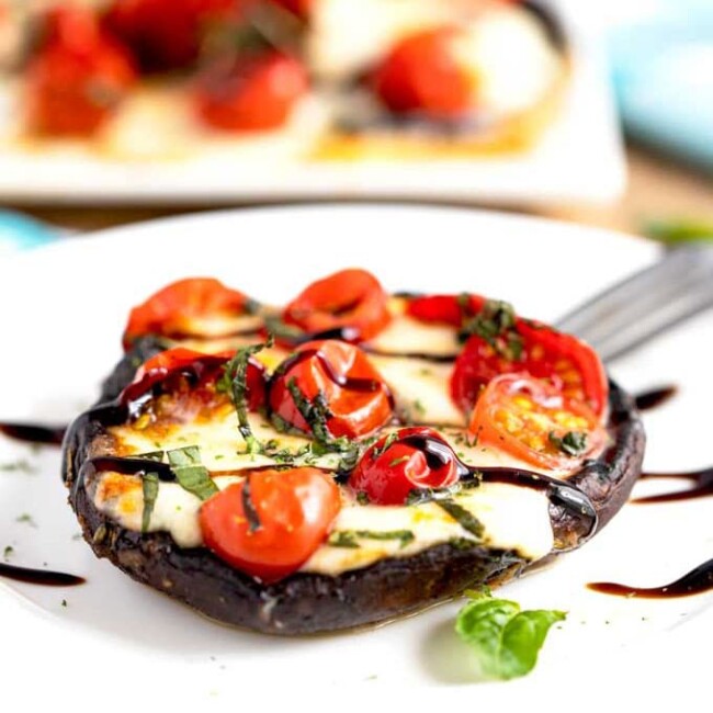 A single stuffed mushroom on a white plate