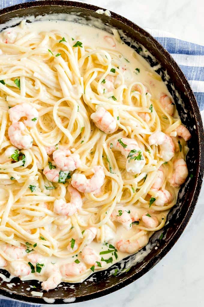 A skillet filled with creamy Shrimp Fettuccine  Alfredo.