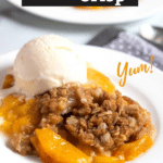 Peach crisp with vanilla ice cream on a white plate