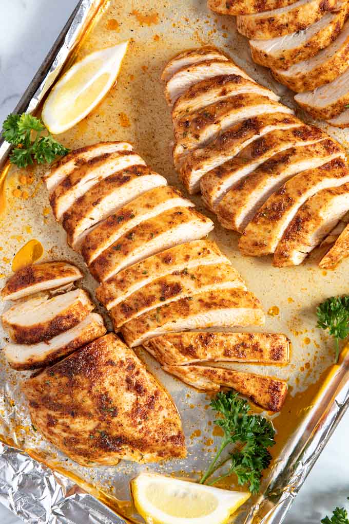 Baked Chicken breast sliced on a sheet pan