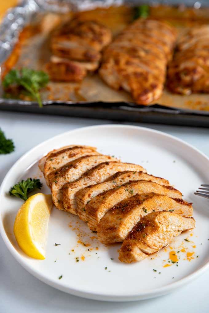 Sliced chicken breast on a white plate.