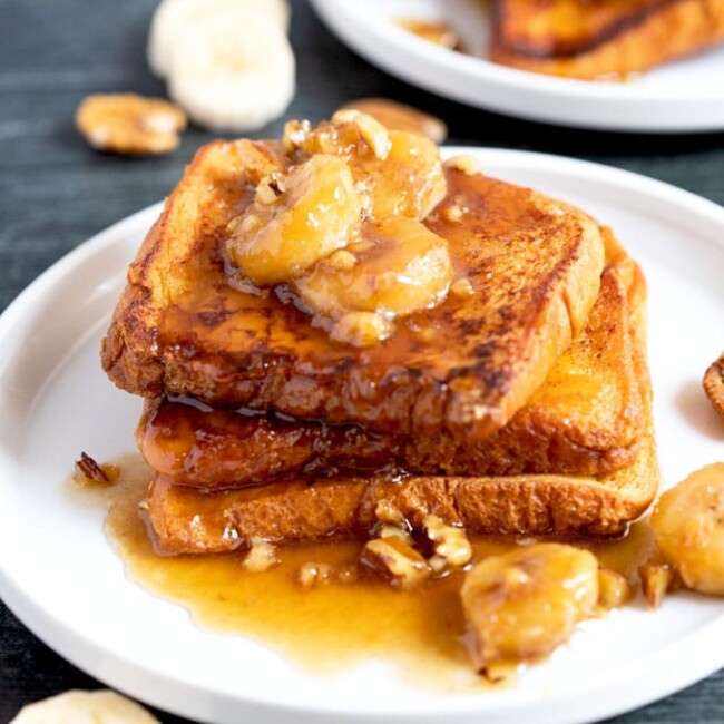 Banana Foster topping served over French toast on a white plate.