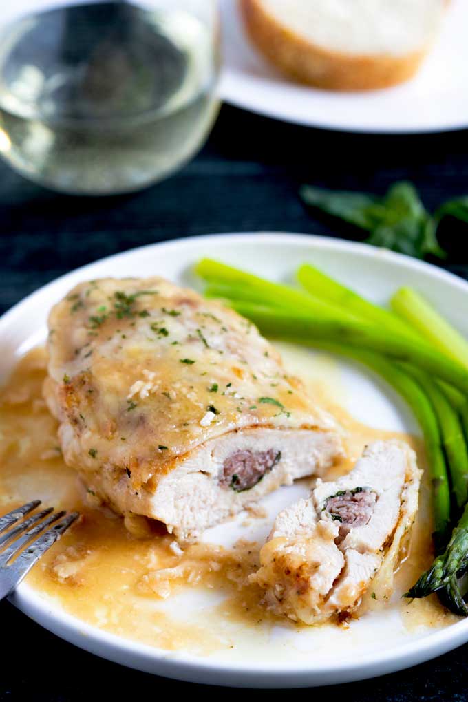 Stuffed chicken Saltimbocca topped with cheese 